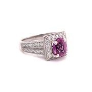 Pink sapphire and diamond ring shown at an angle.