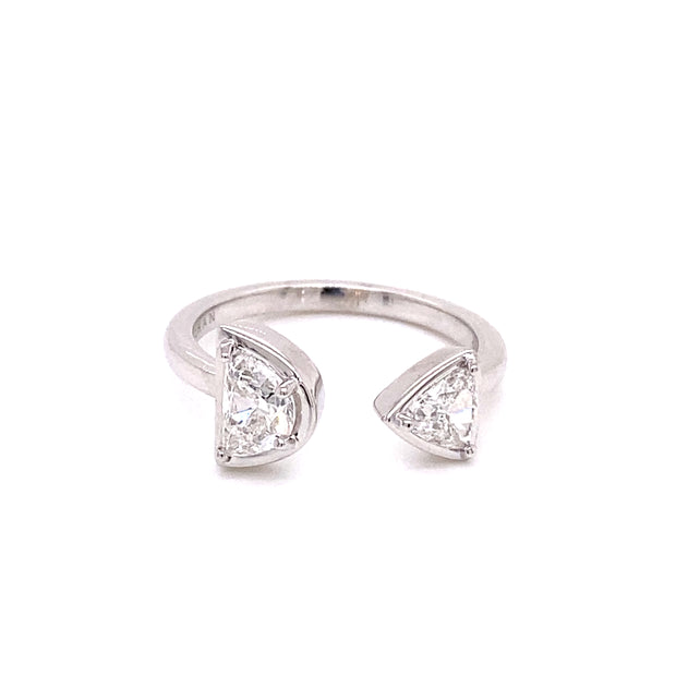 A two-stone bypass ring set with half moon and trillion cut diamonds, set in 18K white gold.