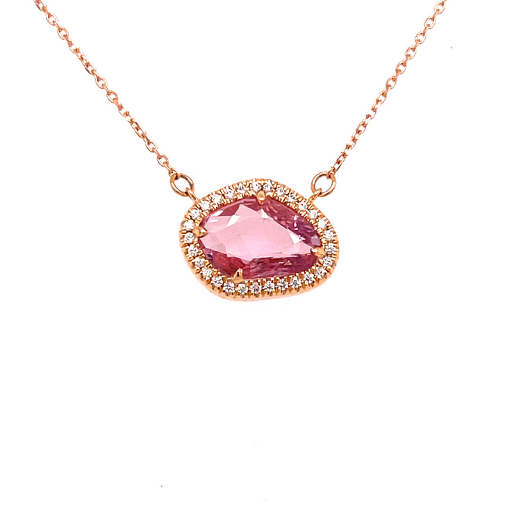 Surrounding the center stone, a delicate halo of 0.08 carats of round brilliant cut diamonds.