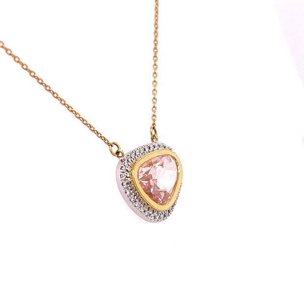 A side view of the pink sapphire and diamond pendant necklace.