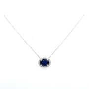 Sapphire and round brilliant diamond halo necklace.