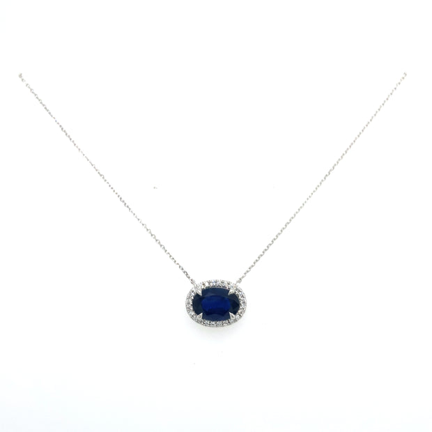 Sapphire and round brilliant diamond halo necklace.