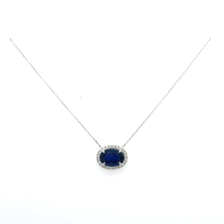 Sapphire and round brilliant diamond halo necklace.