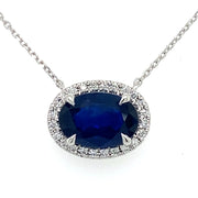 Deep blue Sapphire sits at the center of natural diamond halo on an 18inch white gold chain