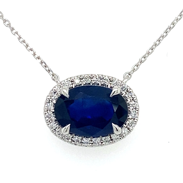 Deep blue Sapphire sits at the center of natural diamond halo on an 18inch white gold chain