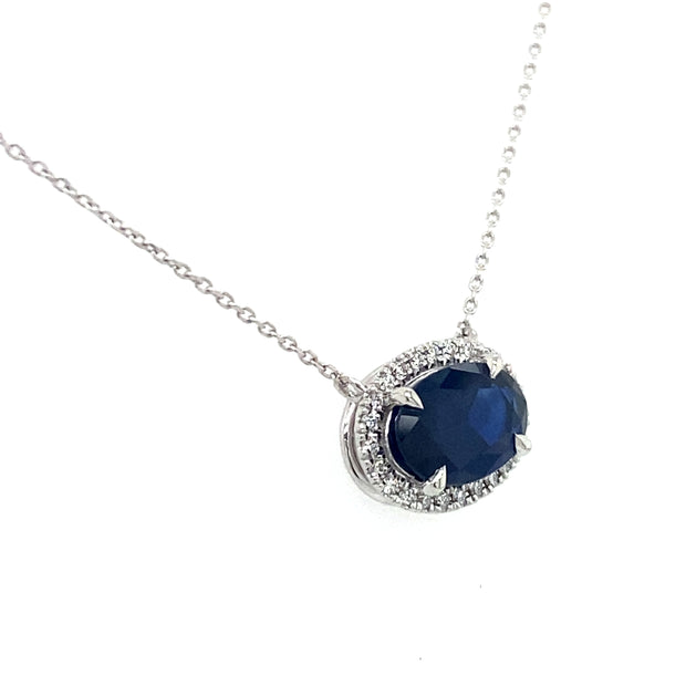Side view of the sapphire diamond halo necklace.
