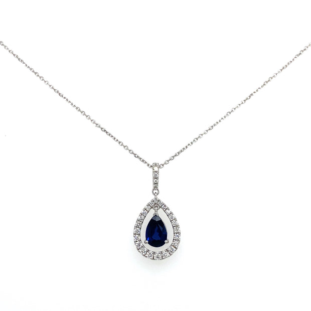 A detailed view of the vibrant sapphire at the center of a sparkling diamond halo.