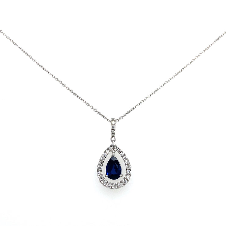 A detailed view of the vibrant sapphire at the center of a sparkling diamond halo.
