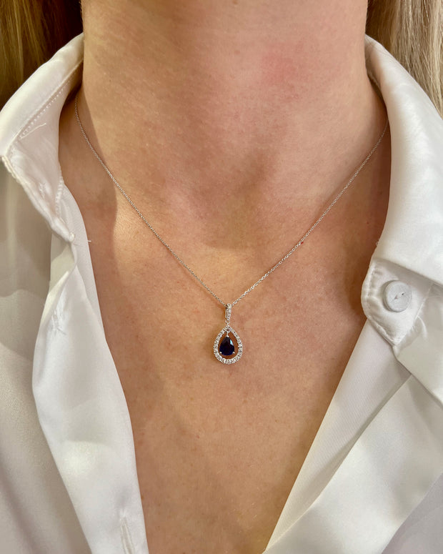 The sapphire diamond halo pendant shown on model.