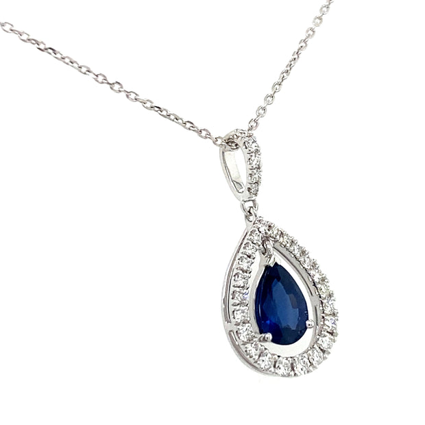 Sapphire pendant with natural diamond halo shown from an angle.