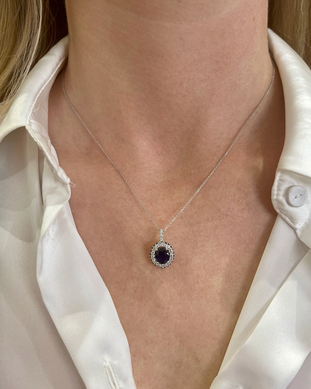 Oval sapphire and diamond pendant shown on model.