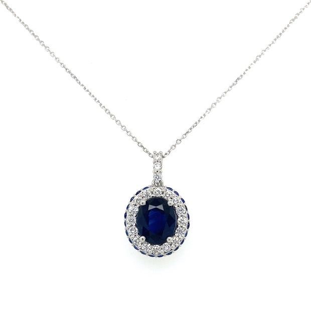Oval sapphire center with inner diamond halo and outter sapphire halo.
