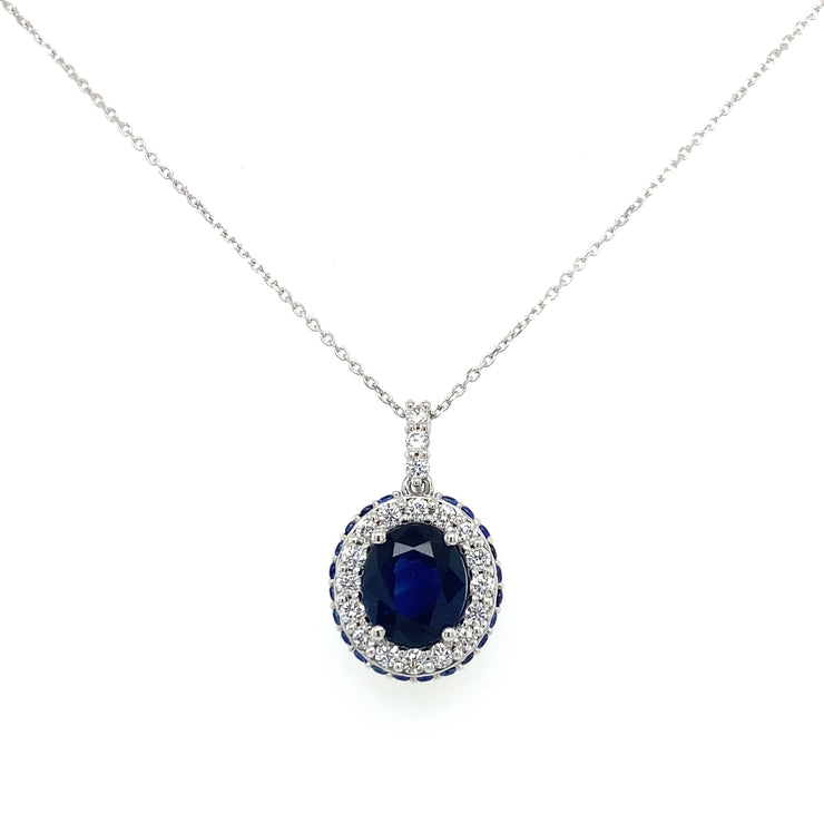 Oval sapphire center with inner diamond halo and outter sapphire halo.