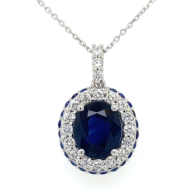 An 18K white gold necklace featuring a 2.23 CT oval sapphire center stone with  diamond accents.