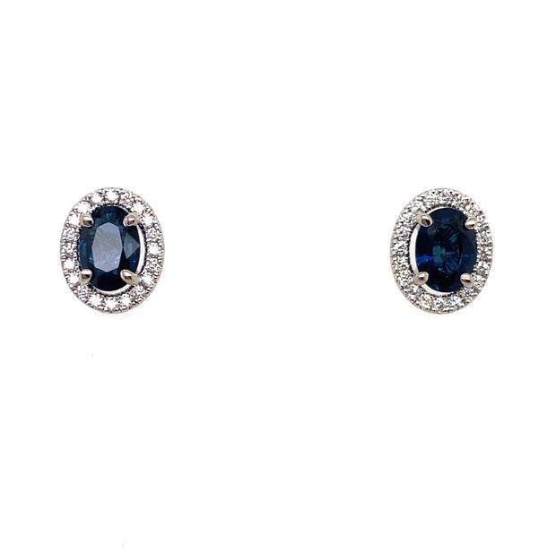 Closer detail of the oval sapphire and diamond halo stud earrings.