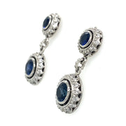 A detailed side view of the sapphire drop earrings with diamond halos.