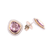 A closer detail of the pink sappire and diamond halo earrings in yellow and white gold.