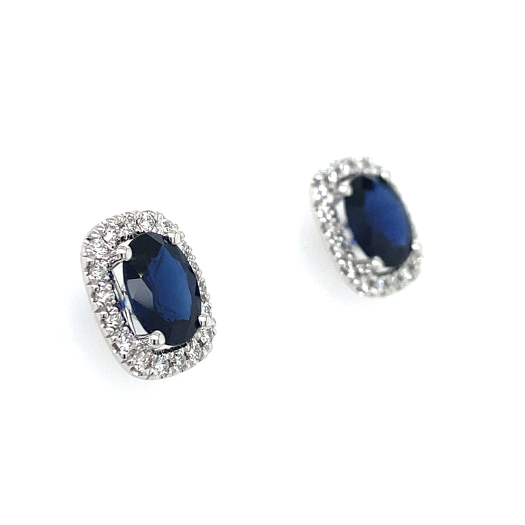 A detailed side view of the sapphire and diamond halo earrings.