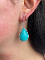 Model wearing 18K white gold turquoise and diamond dangle earrings