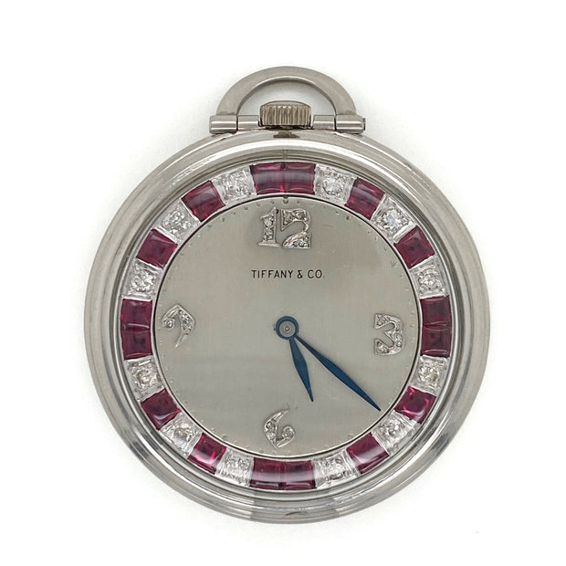 Front view of the pocket watch showing the diamond and ruby-set dial.