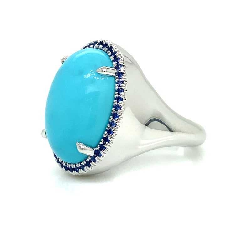 Side view of Turquoise cabochon center stone surrounded by blue sapphire halo