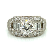 A Round brilliant center with a cascade of baguette and round side stones make this unique vintage ring a delicate balance of light, shape, and sentiment.

