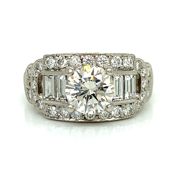 A Round brilliant center with a cascade of baguette and round side stones make this unique vintage ring a delicate balance of light, shape, and sentiment.

