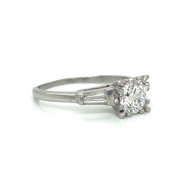 Side profile revealing the platinum setting and low-profile design.