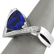 Close-up of Trillion-cut Tanzanite gemstone ring with pave diamond details