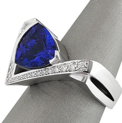 Close-up of Trillion-cut Tanzanite gemstone ring with pave diamond details