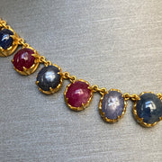 Close-up of gemstone settings and rich 22K gold detailing.