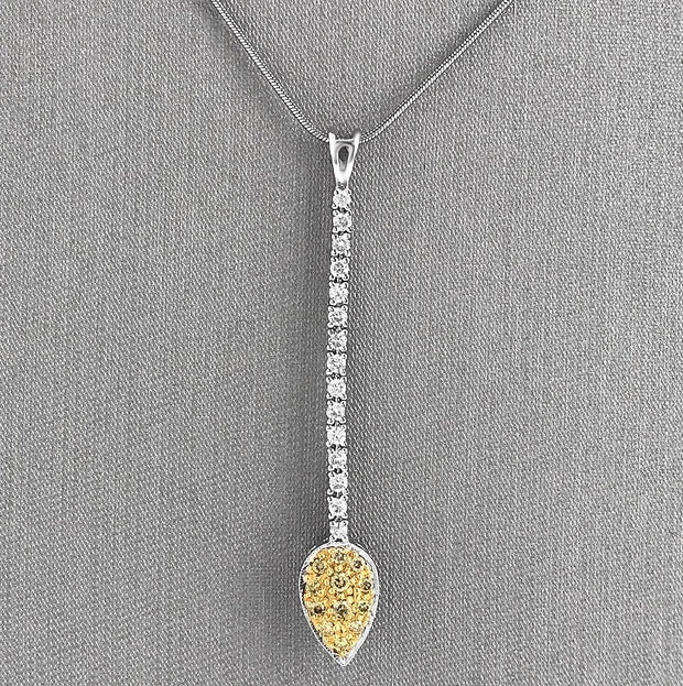 Suspended from a sleek 16-inch snake chain, this pendant is a refined statement piece.