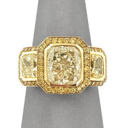 Yellow diamond three stone halo ring