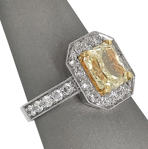 Radiant Fancy Yellow Diamond ring with halo in two tone 18 karat gold
