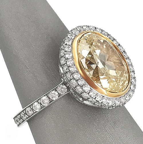 Fancy Yellow Oval Diamond in platinum diamond halo ring