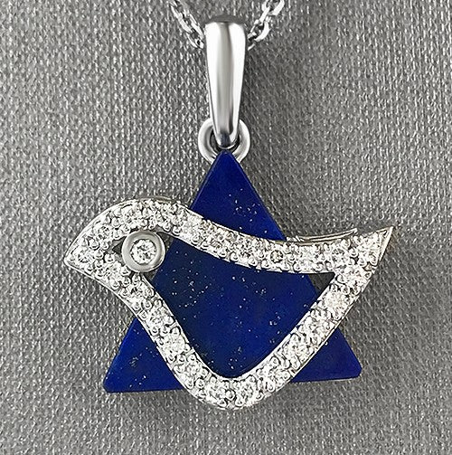 An 18 karat white gold dove pendant set with round brilliant cut diamonds, featuring a blue lapis lazuli background.