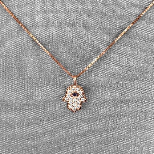 Bezel-set blue sapphire center for a vivid pop of color.