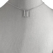  Petite bar design with dangle detail for subtle movement .