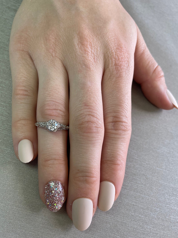 Worn on hand to display the ring’s delicate proportions and antique charm.
