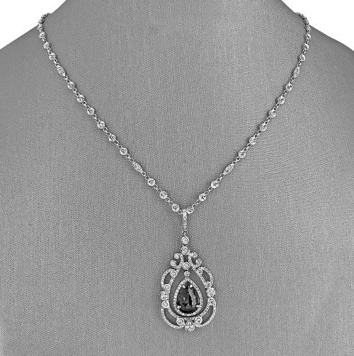 A 14 karat white gold necklace pendant featuring natural black and white diamonds.