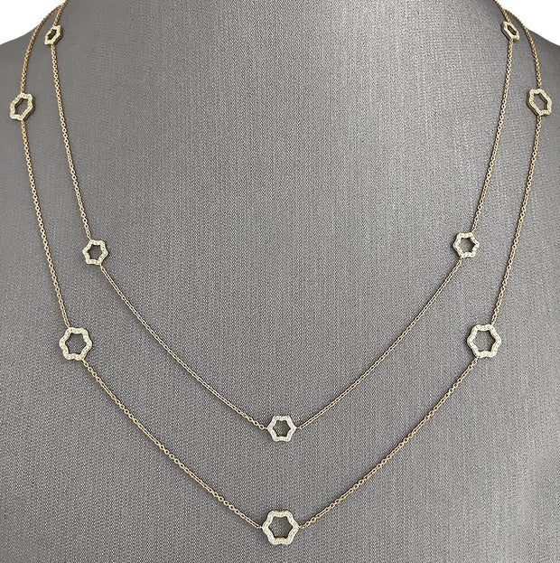 A yellow gold necklace with six floral-inspired open motifs, each accented with sparkling round brilliant diamonds.