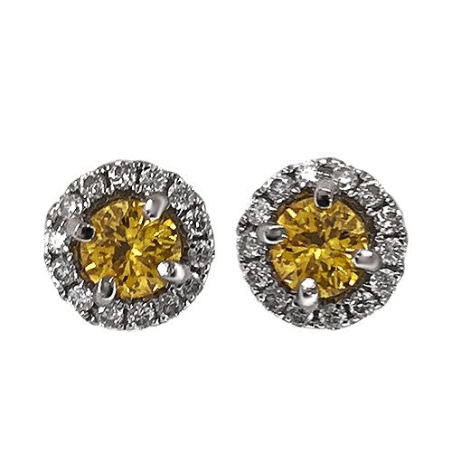 A pair of 18 karat white gold diamond halo stud earrings with fancy yellow round brilliant cut diamonds.