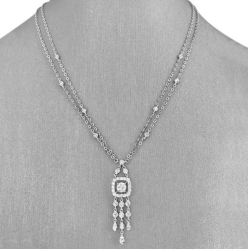 An 18 karat white gold necklace with a diamond drop pendant design.