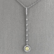 Graceful movement and radiant contrast define this elegant diamond dangle pendant. Crafted in luminous 18K white gold.