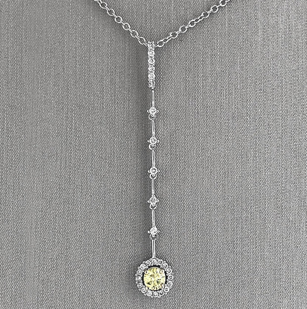 Graceful movement and radiant contrast define this elegant diamond dangle pendant. Crafted in luminous 18K white gold.