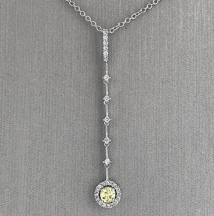 Graceful movement and radiant contrast define this elegant diamond dangle pendant. Crafted in luminous 18K white gold.