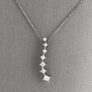 A close detail of the seven princess-cut diamond cascading pendant.