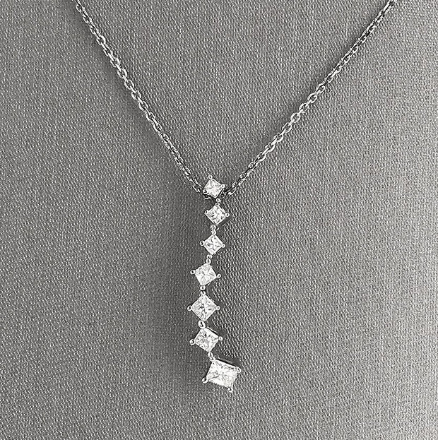 A close detail of the seven princess-cut diamond cascading pendant.