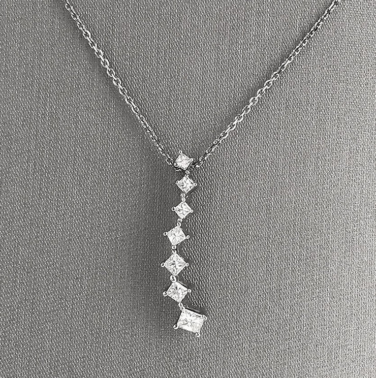 A close detail of the seven princess-cut diamond cascading pendant.
