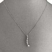 A 14 karat white gold cascading diamond pendant set with 7 princess cut diamonds.
